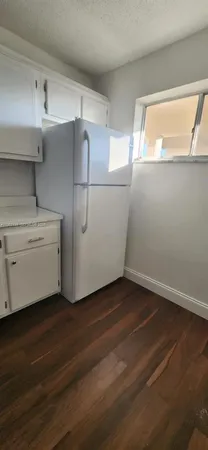 a room with cabinets and wooden floor