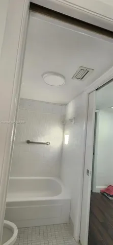 a bathroom with a shower and a toilet