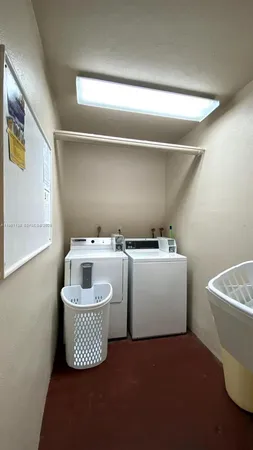 a room with a washing machine and sink