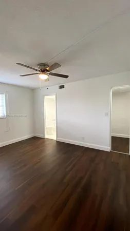 a view of a room with wooden floor and iron stairs