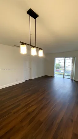 an empty room with wooden floor
