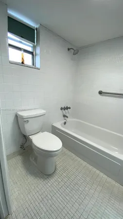 a room with a wooden floor and white wall