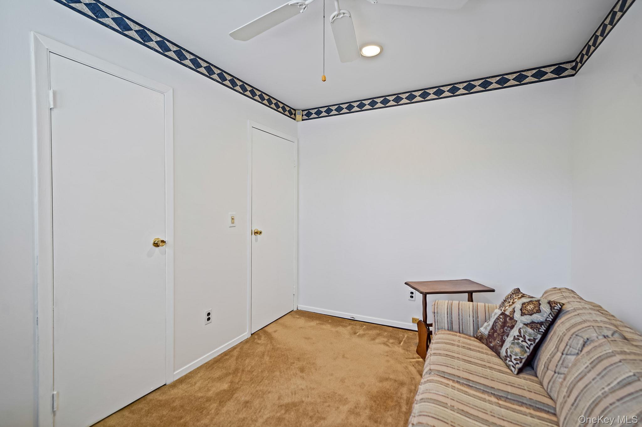 8 Huntington Commons, Unit 8 Yaphank, NY 11980 - Photo 14 of 30 a view of a bedroom with a bed and wooden floor