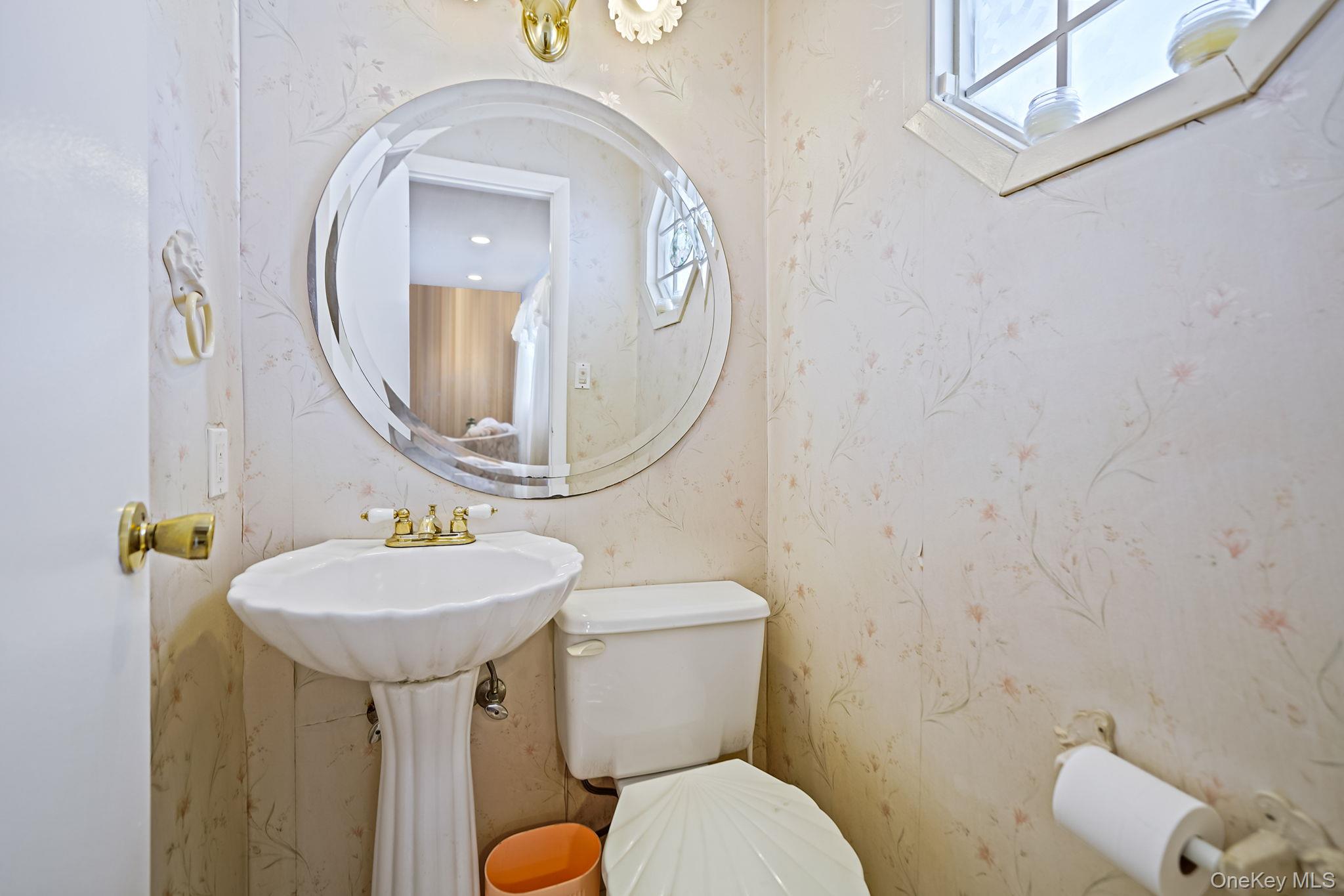 8 Huntington Commons, Unit 8 Yaphank, NY 11980 - Photo 15 of 30 a bathroom with a toilet sink and mirror