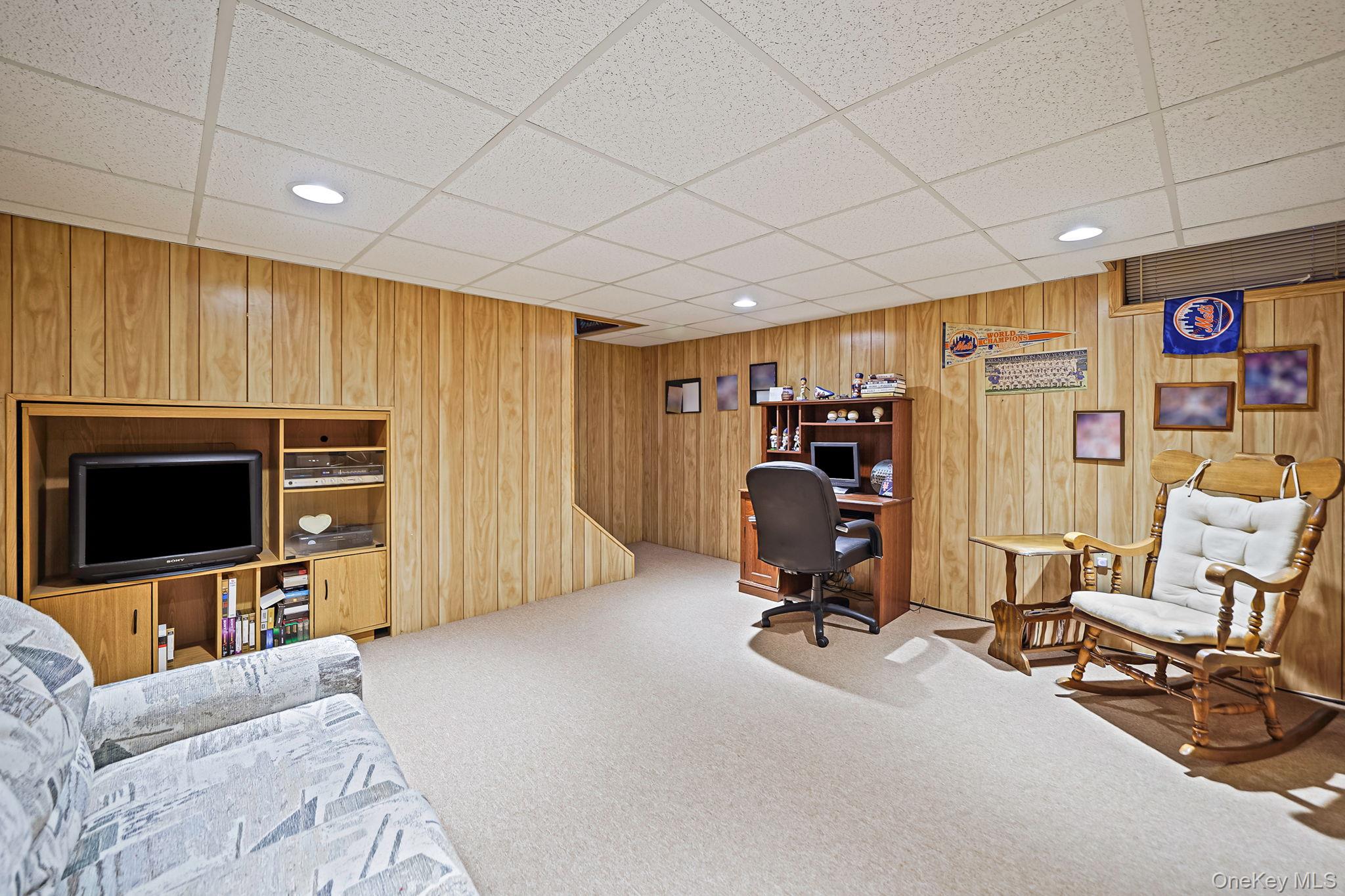 8 Huntington Commons, Unit 8 Yaphank, NY 11980 - Photo 28 of 30 a view of a livingroom with workspace and a window
