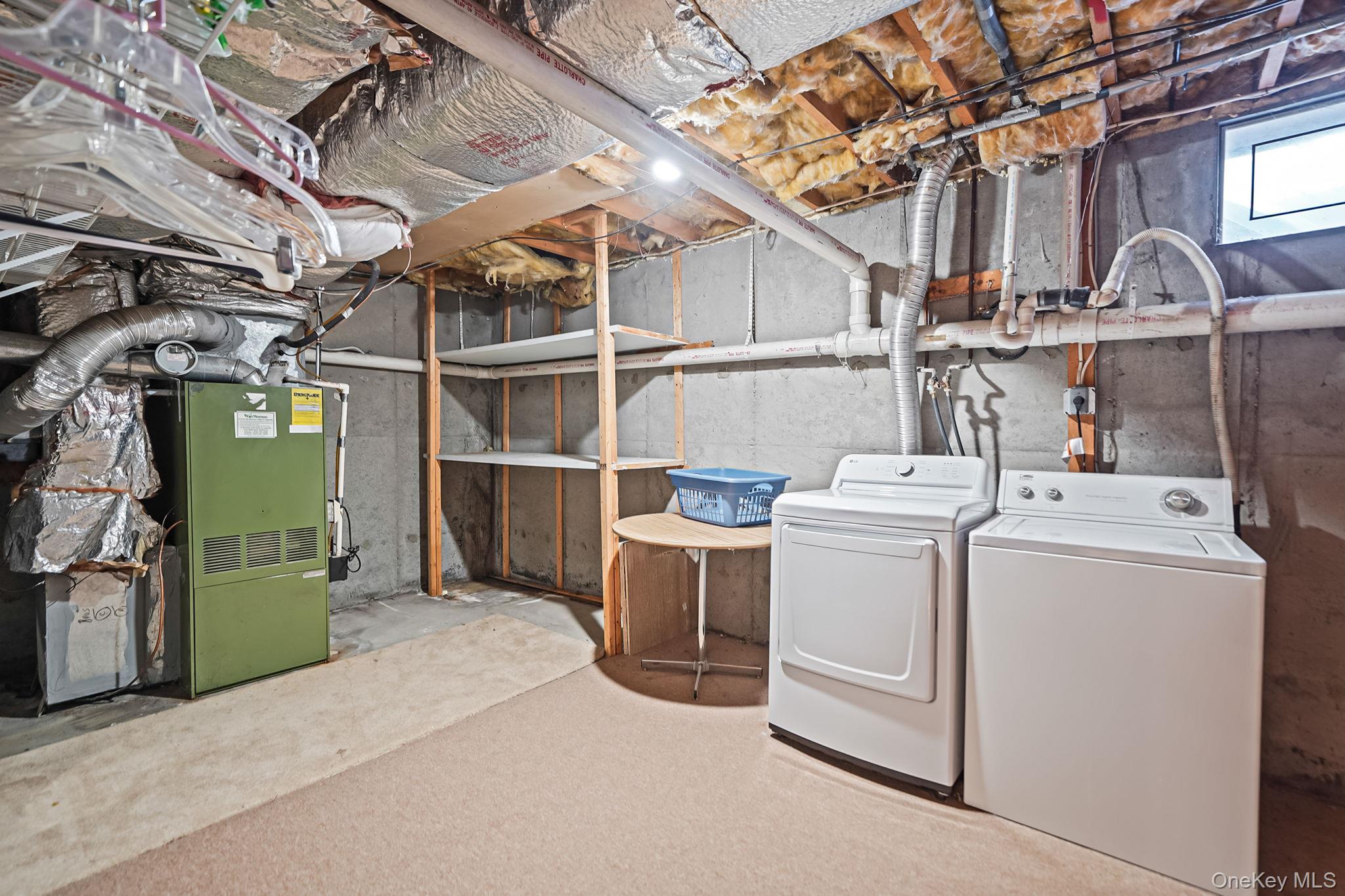 8 Huntington Commons, Unit 8 Yaphank, NY 11980 - Photo 29 of 30 a utility room with dryer and washer