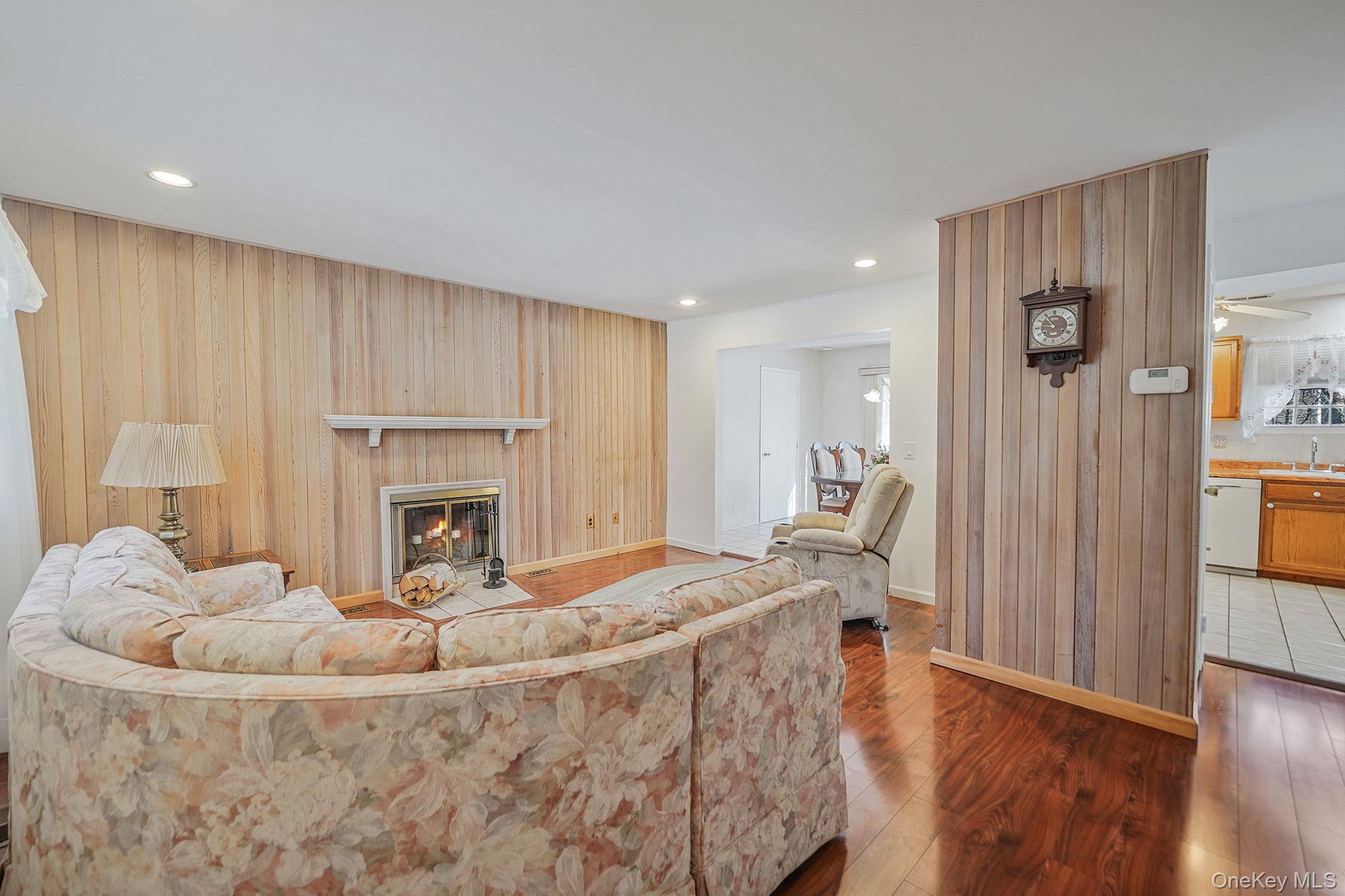 8 Huntington Commons, Unit 8 Yaphank, NY 11980 - Photo 3 of 30 a living room with furniture and a fireplace