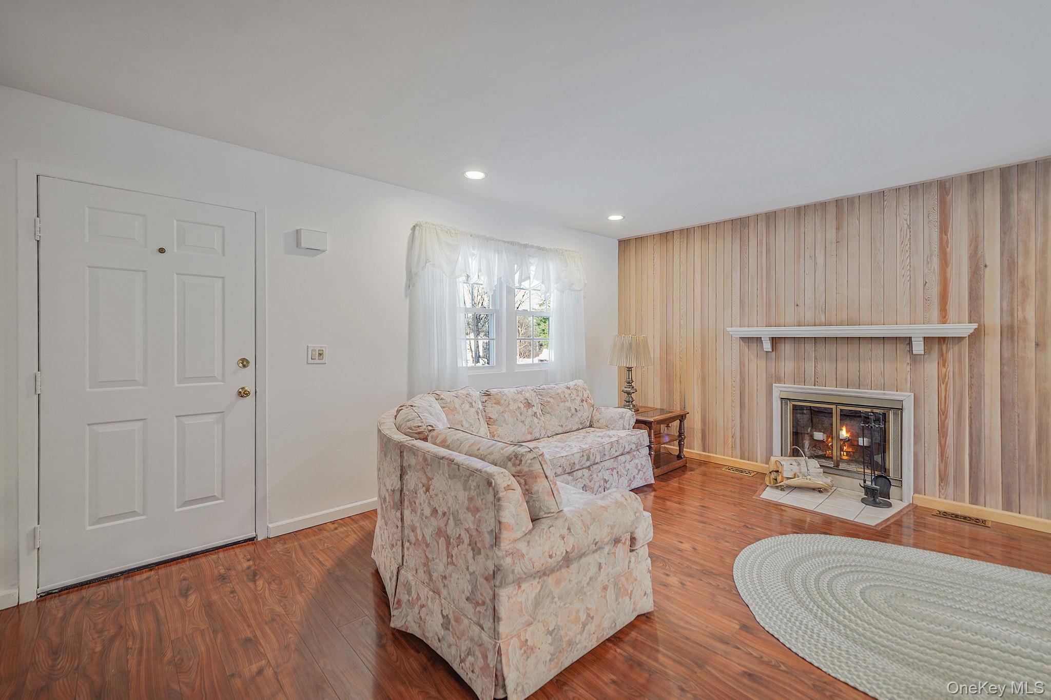 8 Huntington Commons, Unit 8 Yaphank, NY 11980 - Photo 4 of 30 a living room with furniture and a fireplace