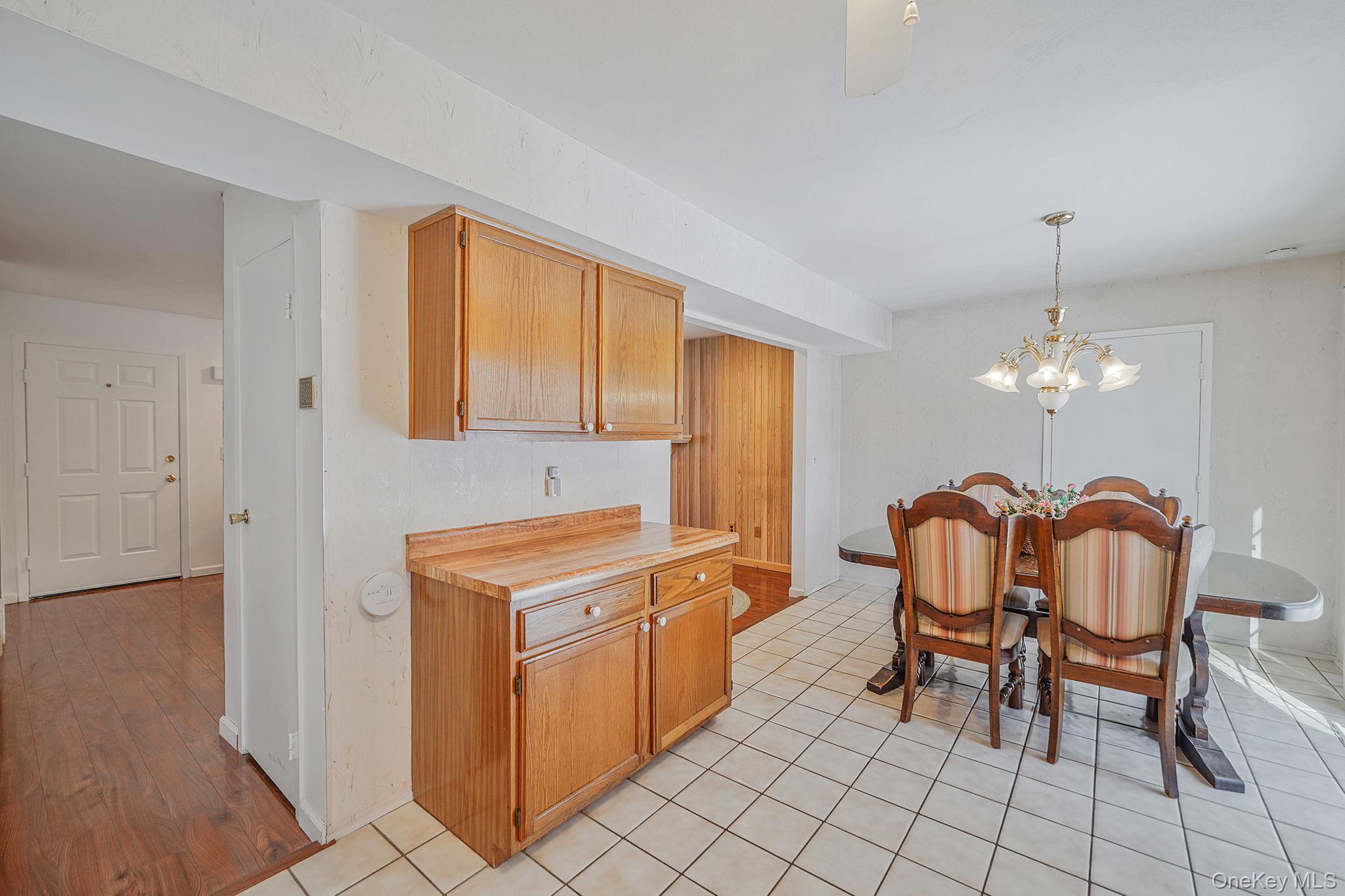 8 Huntington Commons, Unit 8 Yaphank, NY 11980 - Photo 10 of 30 a dining room with furniture and chandelier