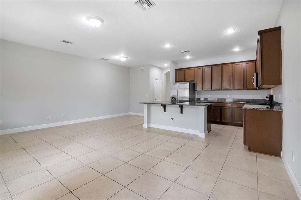12357 Via Derna Place Windermere, FL 34786 - Photo 11 of 33 a kitchen with stainless steel appliances granite countertop a refrigerator and a sink