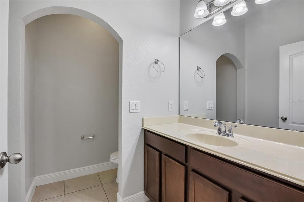 12357 Via Derna Place Windermere, FL 34786 - Photo 7 of 33 a bathroom with a sink a light fixture and a mirror