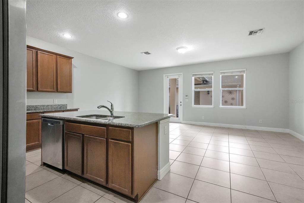 12357 Via Derna Place Windermere, FL 34786 - Photo 8 of 33 a kitchen with a sink cabinets and window