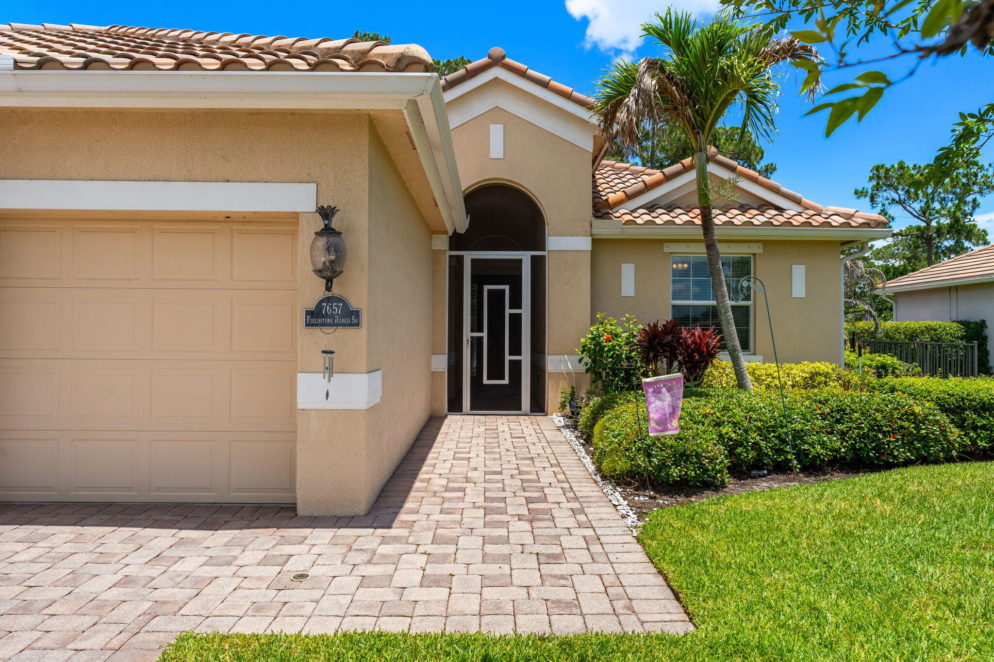 7657 Fieldstone Ranch Square Vero Beach, FL 32967 - Photo 5 of 52 a front view of a house with garden