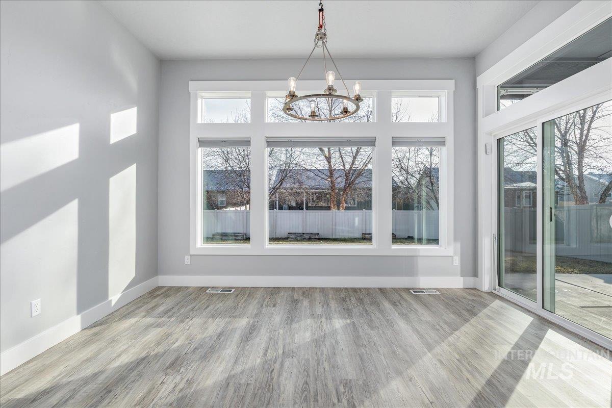 3036 Northwest 13th Street Meridian, ID 83646 - Photo 16 of 50 Unfurnished dining area with light wood finished floors and suspended lighting