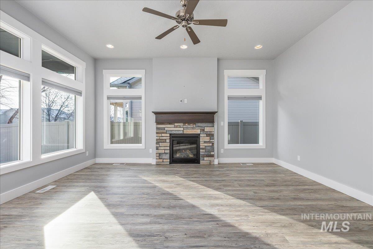 3036 Northwest 13th Street Meridian, ID 83646 - Photo 19 of 50 Unfurnished living room featuring light wood-type flooring, a fireplace, recessed lighting, and ceiling fan