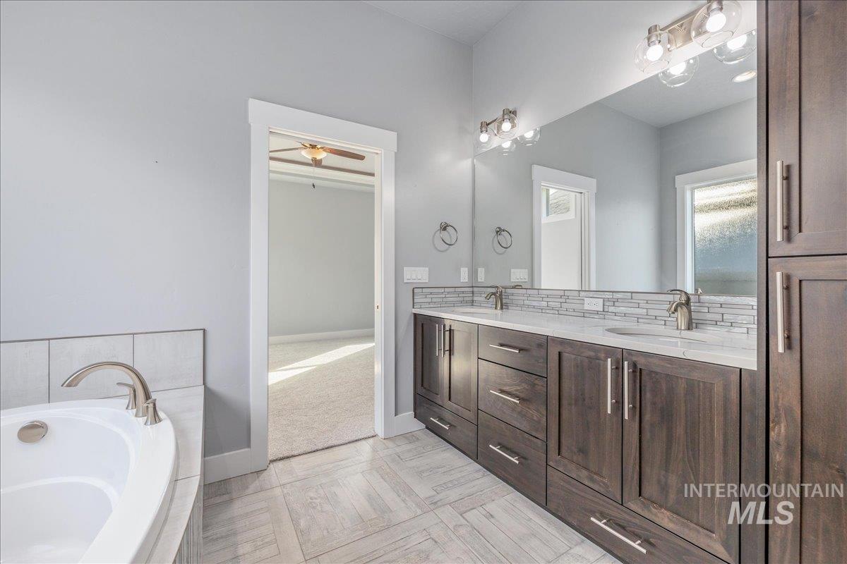 3036 Northwest 13th Street Meridian, ID 83646 - Photo 25 of 50 Full bathroom featuring double vanity and a bath