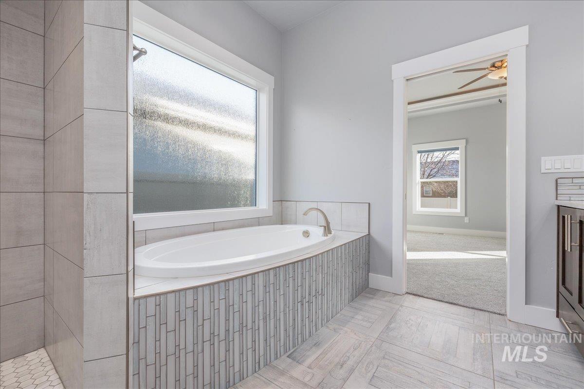 3036 Northwest 13th Street Meridian, ID 83646 - Photo 26 of 50 Bathroom with a bath, vanity, and ceiling fan