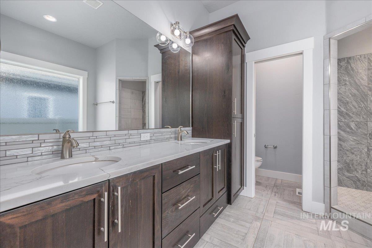 3036 Northwest 13th Street Meridian, ID 83646 - Photo 27 of 50 Bathroom featuring double vanity and a tile shower