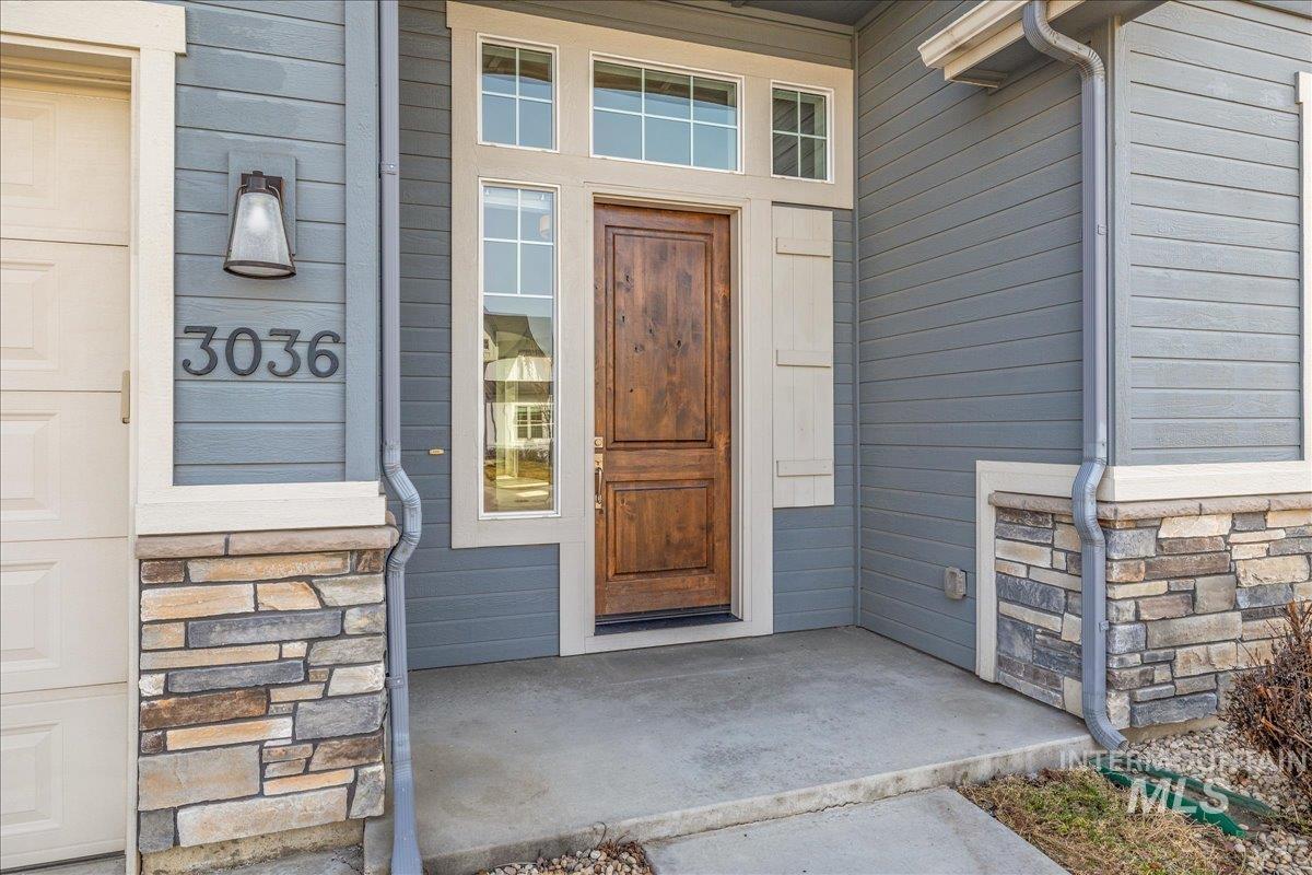 3036 Northwest 13th Street Meridian, ID 83646 - Photo 3 of 50 Doorway to property featuring stone siding and a porch