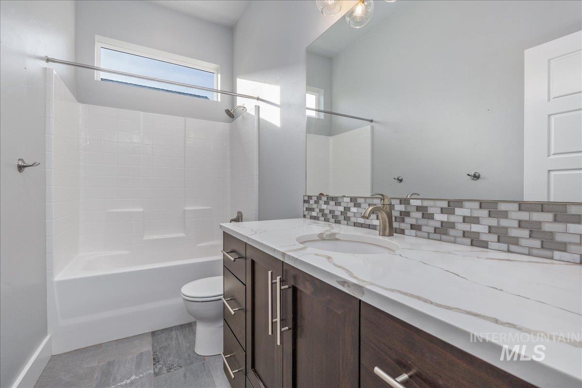 3036 Northwest 13th Street Meridian, ID 83646 - Photo 32 of 50 Bathroom with vanity, washtub / shower combination, and backsplash