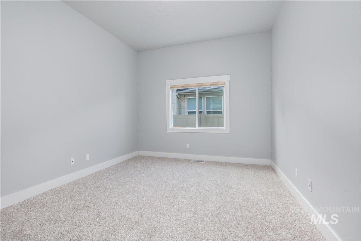 3036 Northwest 13th Street Meridian, ID 83646 - Photo 33 of 50 Spare room with light colored carpet and baseboards