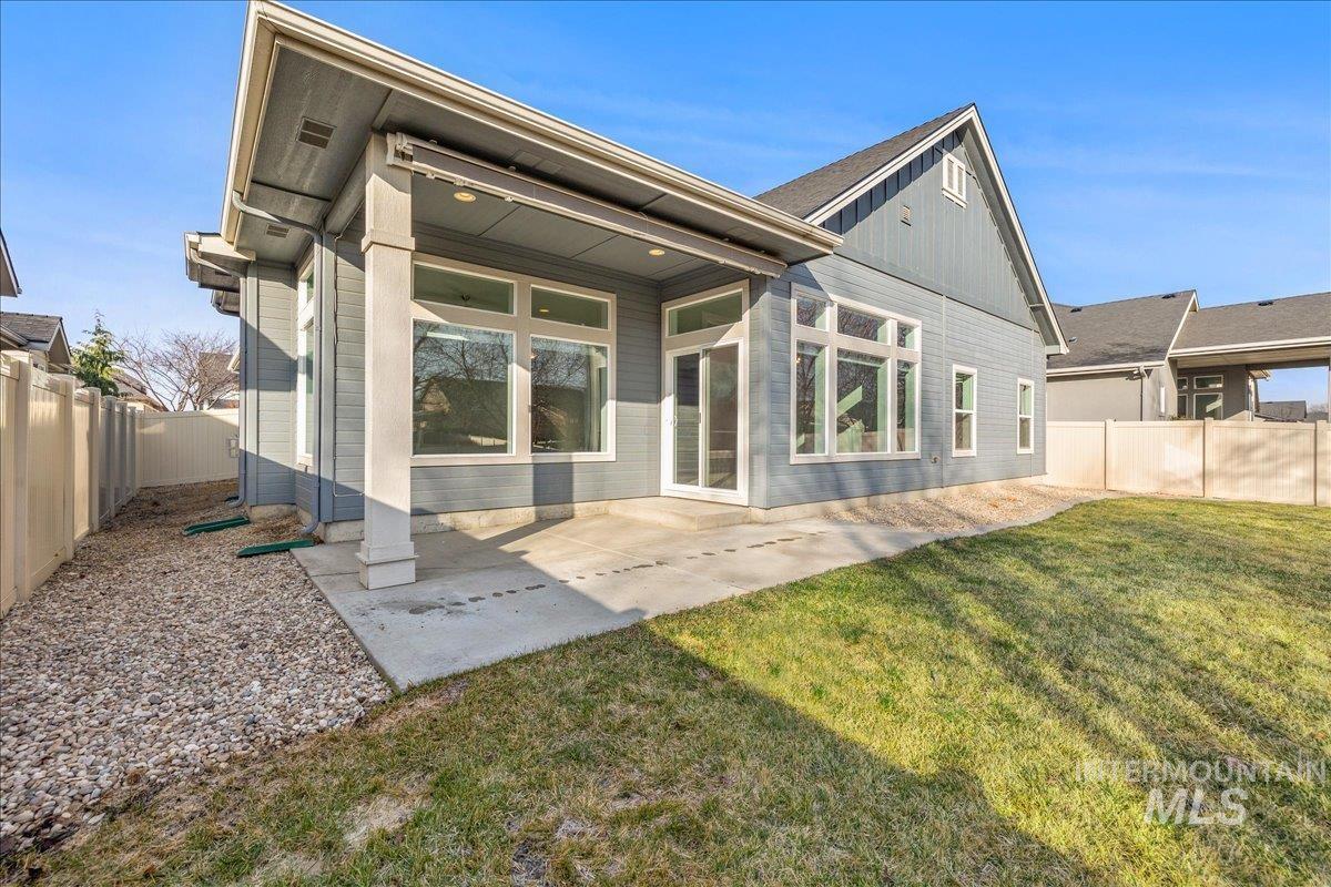 3036 Northwest 13th Street Meridian, ID 83646 - Photo 35 of 50 Rear view of house featuring a fenced backyard and a patio area