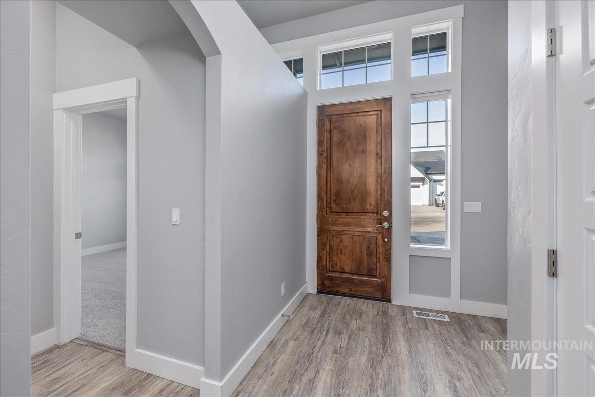 3036 Northwest 13th Street Meridian, ID 83646 - Photo 4 of 50 Entryway with light wood-style flooring and arched walkways