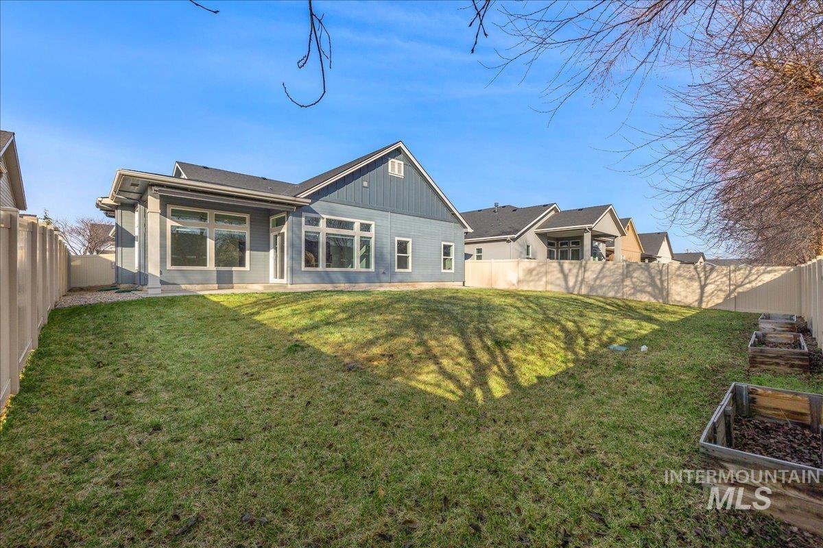 3036 Northwest 13th Street Meridian, ID 83646 - Photo 44 of 50 Rear view of house with a fenced backyard