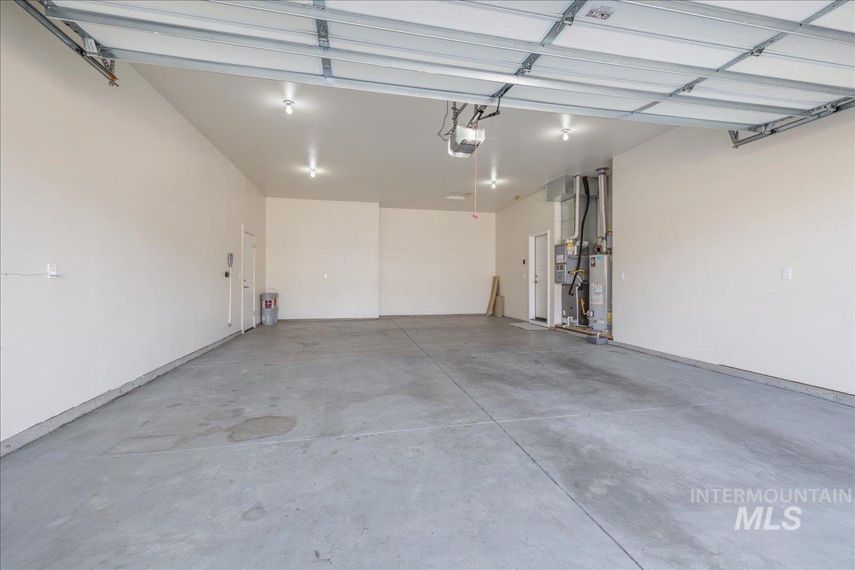 3036 Northwest 13th Street Meridian, ID 83646 - Photo 45 of 50 Garage featuring water heater and a garage door opener