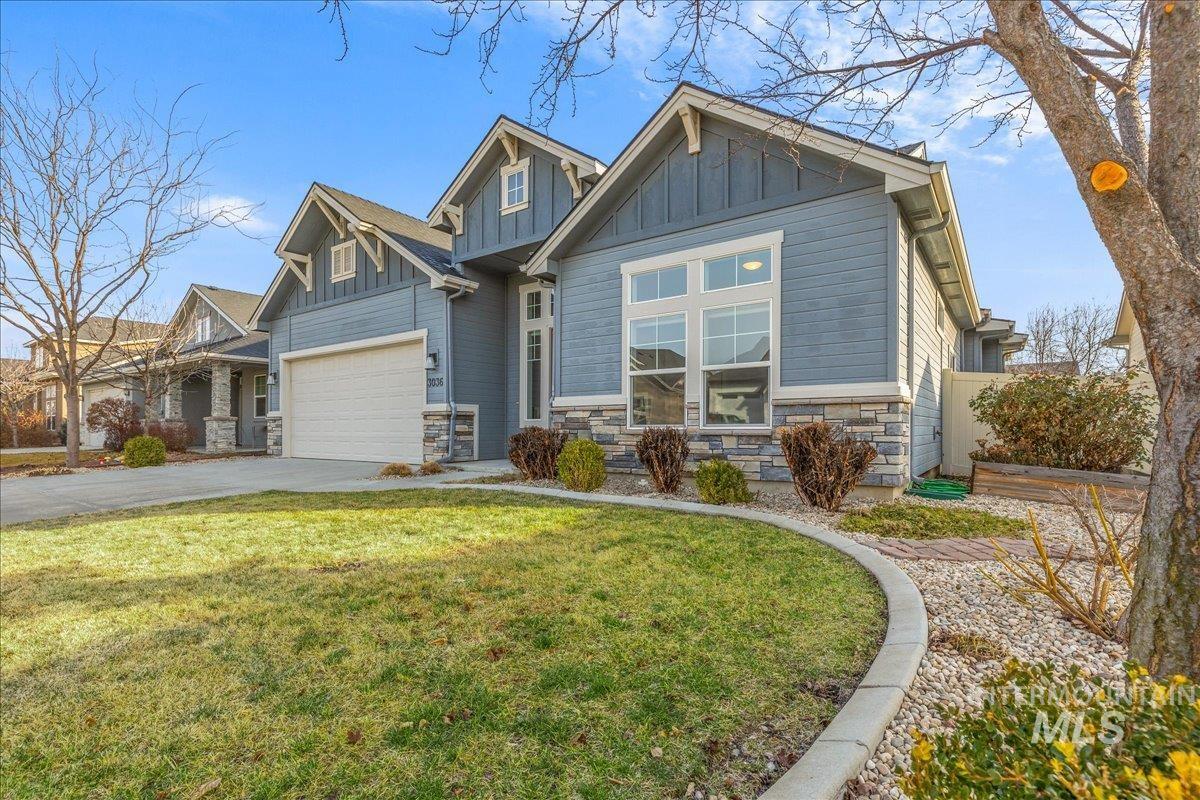 3036 Northwest 13th Street Meridian, ID 83646 - Photo 47 of 50 Craftsman-style home featuring stone siding, board and batten siding, a garage, driveway, and a front yard