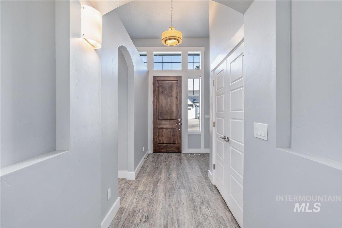 3036 Northwest 13th Street Meridian, ID 83646 - Photo 5 of 50 Entryway with light wood-style floors and arched walkways