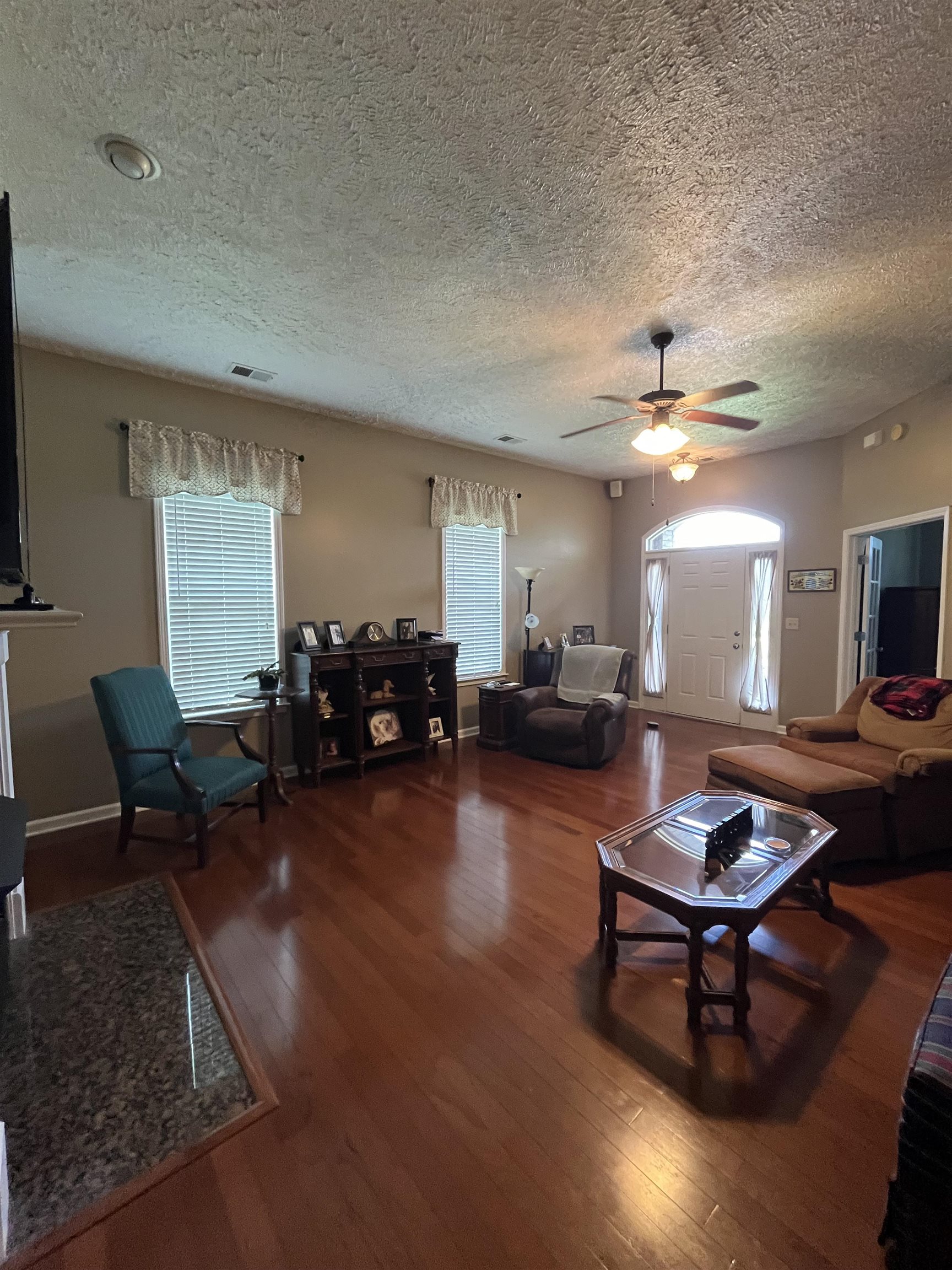 5485 Shipp Road Millington, TN 38053 - Photo 2 of 17 Living room featuring ceiling fan, hardwood / wood-style floors, and a textured ceiling