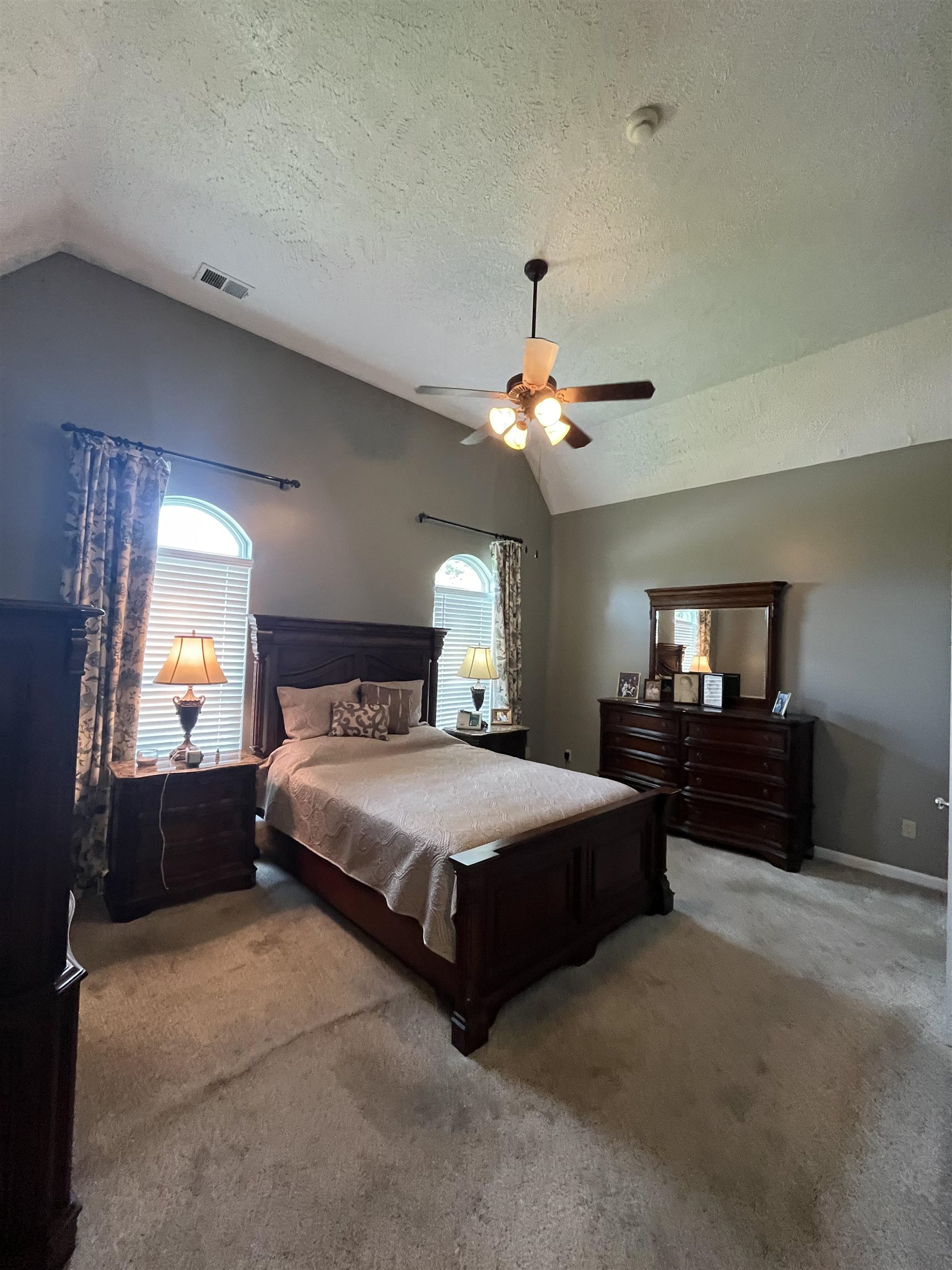5485 Shipp Road Millington, TN 38053 - Photo 6 of 17 Carpeted bedroom featuring a textured ceiling, lofted ceiling, and ceiling fan