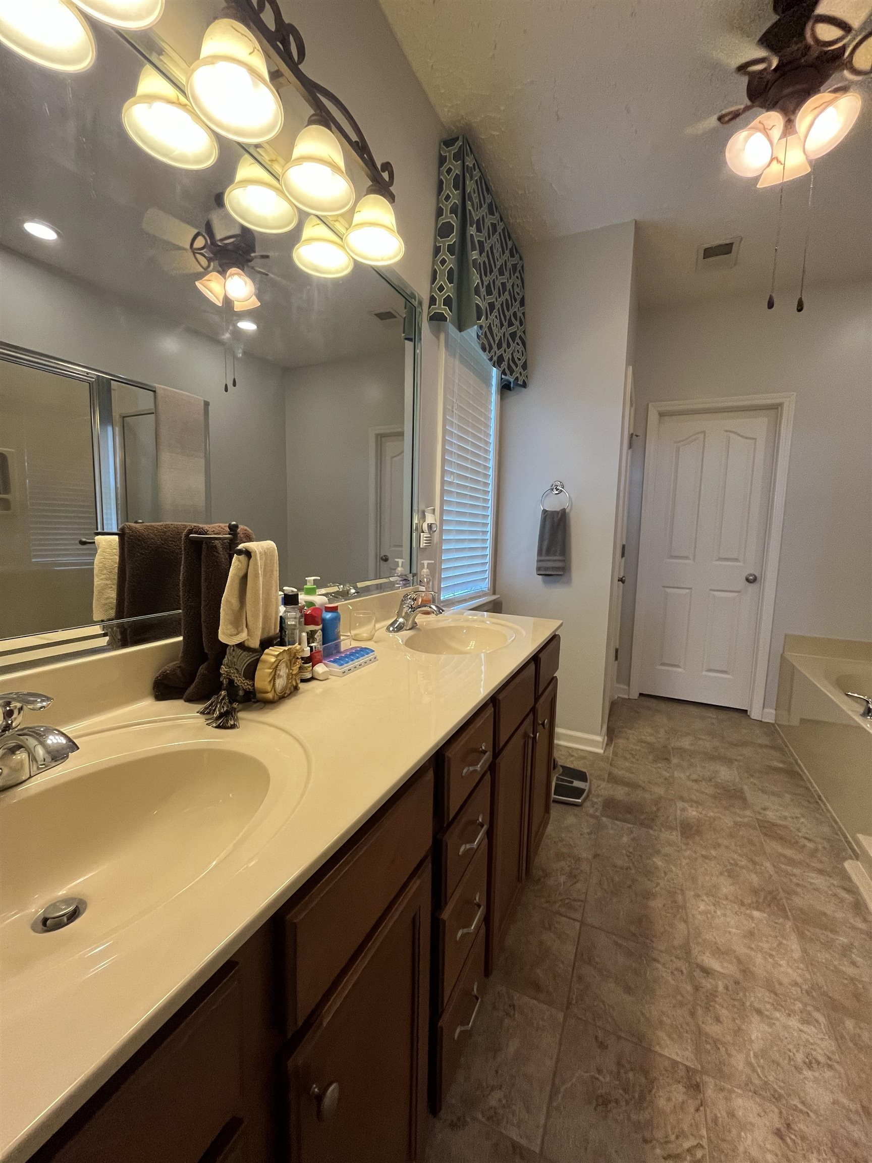 5485 Shipp Road Millington, TN 38053 - Photo 8 of 17 Bathroom featuring ceiling fan, a bathtub, tile patterned floors, and double sink vanity