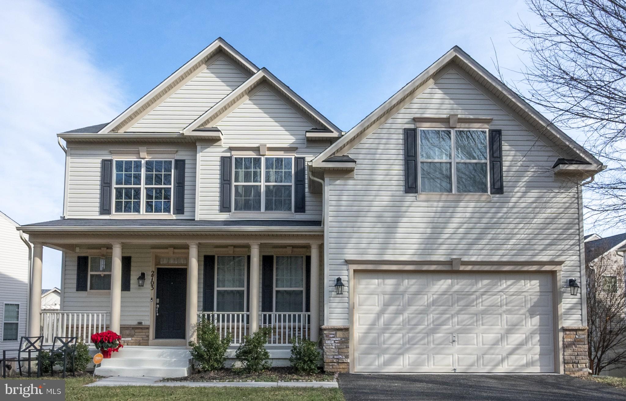 a view of a brick house with lots of potted plants