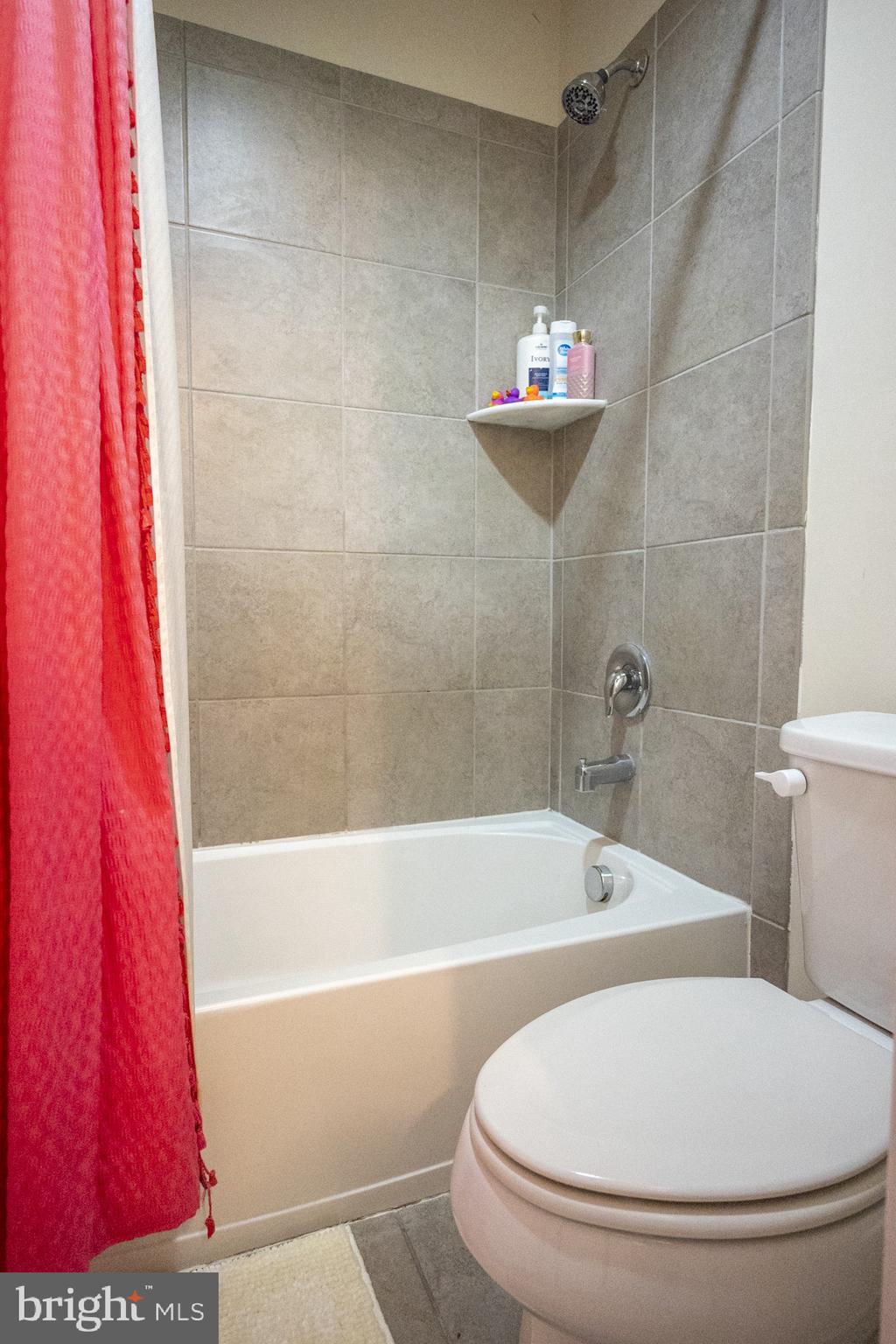 2703 Swann Wing Court Lanham, MD 20706 - Photo 28 of 36 a bathroom with a tub a toilet and a shower