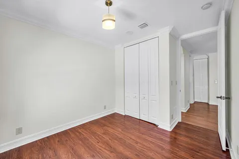 a view of a room with wooden floor