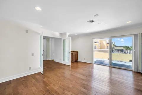 a view of an empty room with glass door