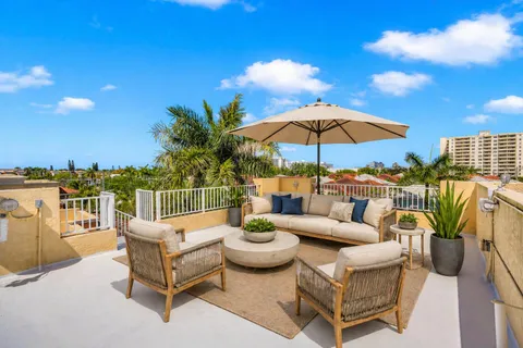 a view of a patio with couches under an umbrella