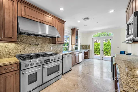 a kitchen with a stove a sink and a microwave
