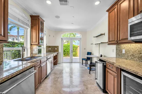 a kitchen with stainless steel appliances granite countertop a stove a sink and a microwave
