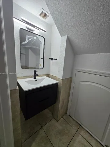 a bathroom with a sink and mirror