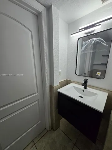 a bathroom with a sink a mirror and vanity
