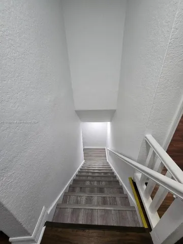 a view of an empty room and wooden floor