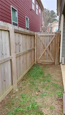 a view of a backyard with a wooden fence
