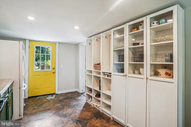 a view of walk in closet with empty racks