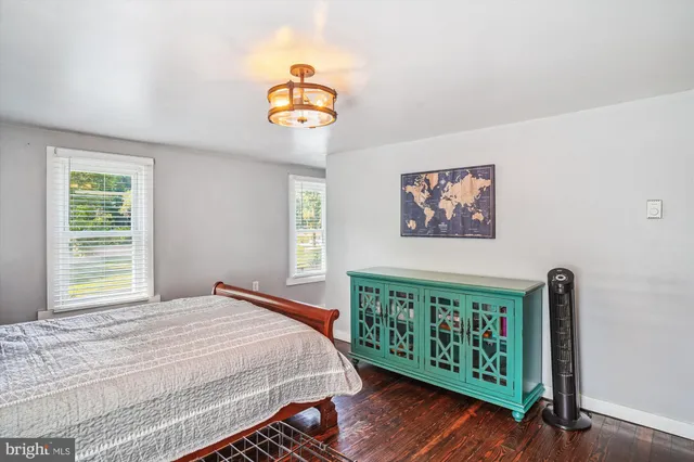 a bedroom with furniture and a window