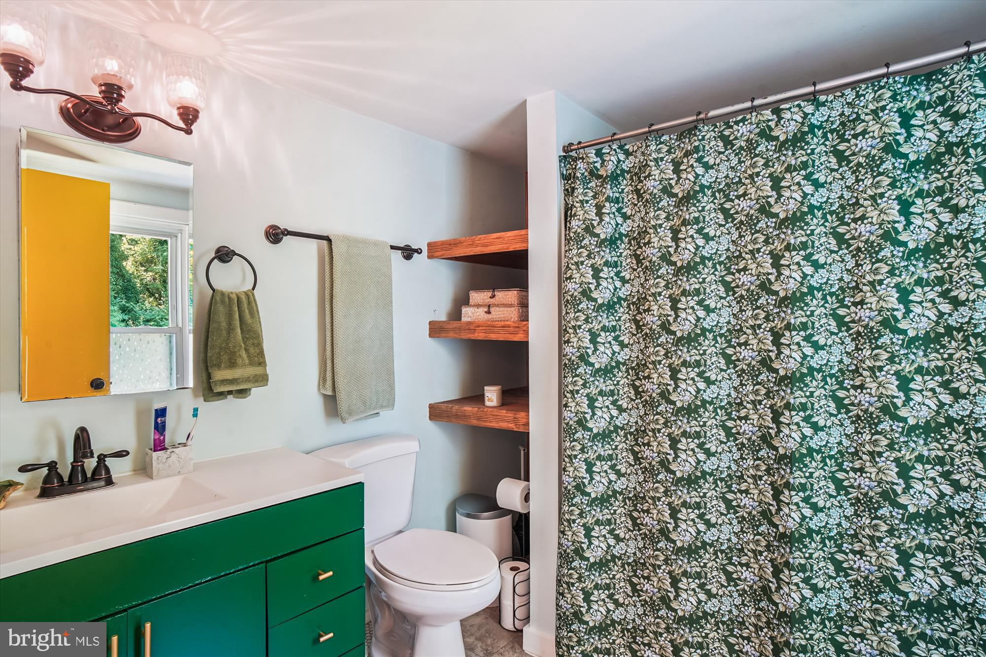 6230 Manor Woods Road Frederick, MD 21703 - Photo 24 of 35 a bathroom with a granite countertop toilet sink and mirror