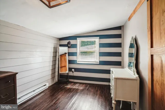 a view of walk in closet with wooden floor and cabinet