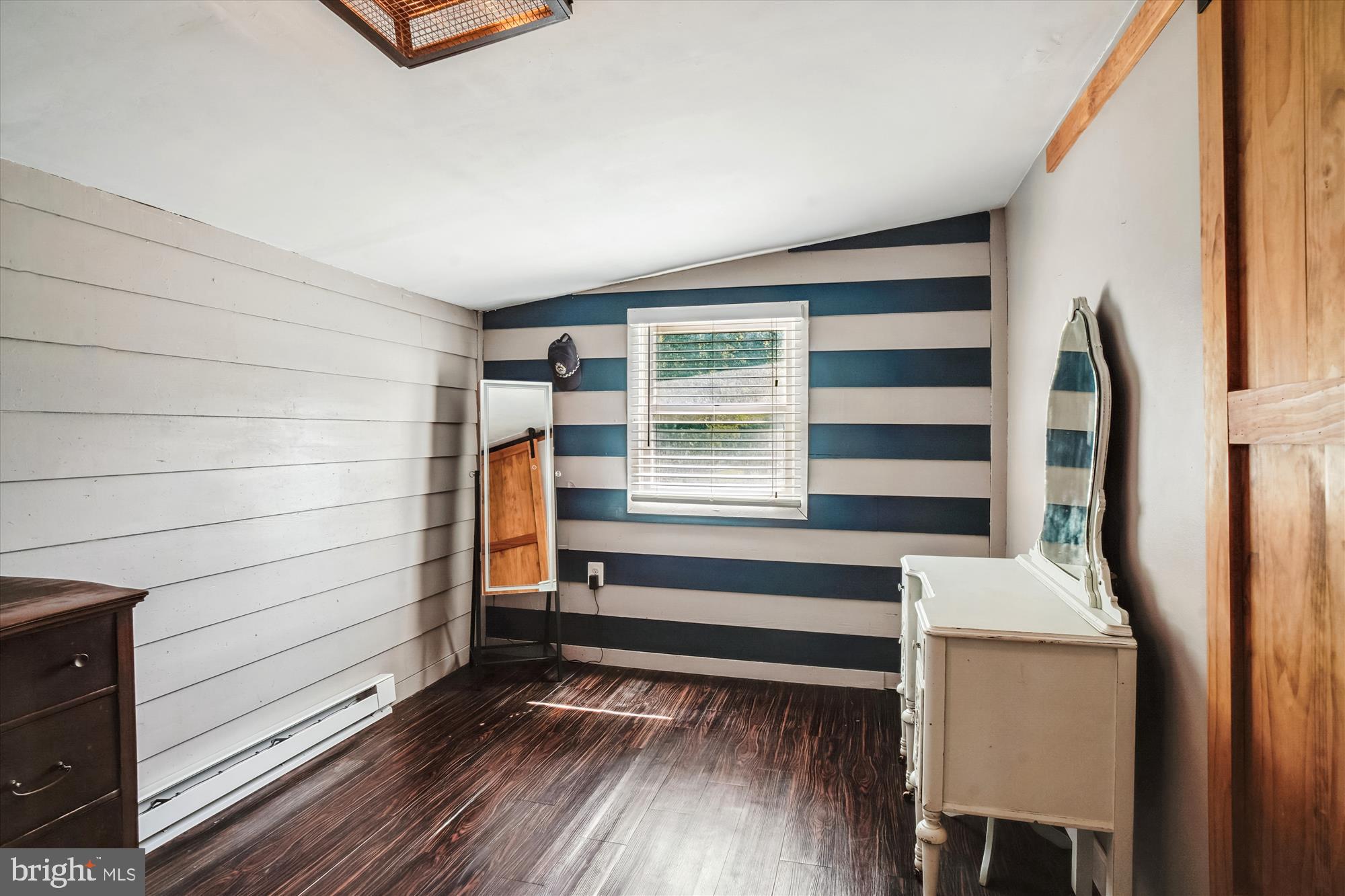 6230 Manor Woods Road Frederick, MD 21703 - Photo 26 of 35 a view of walk in closet with wooden floor and cabinet